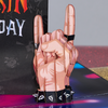 A close-up of a pop-up card with a 3D hand making a rock 'n' roll gesture, adorned with studded wristbands. The background shows a Have a Rockin' Birthday message with music-themed doodles.