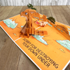 A pop-up card depicting a 3D kangaroo sitting in an Australian desert scene with trees and rocks. The humorous text reads, Sorry for destroying your Down Under, adding a playful touch to the card's theme.