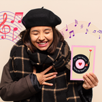 A joyful woman in a cozy outfit holds a "For the Record, You're My Favorite" greeting card, smiling warmly with musical notes in the background, capturing a heartfelt and nostalgic moment.