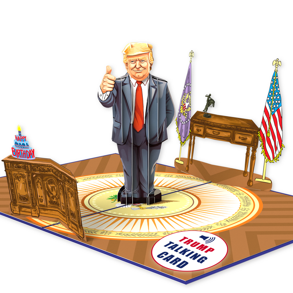 A pop-up card featuring a cartoon figure of Donald Trump giving a thumbs-up, set in an office scene with a desk, flags, and a sign reading Trump Talking Card. A birthday cake graphic with Happy Birthday is also included.