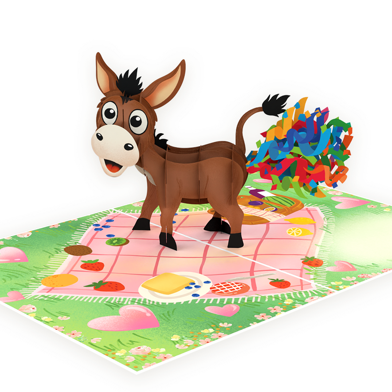 3D pop-up card featuring a cheerful donkey with colorful confetti, standing on a picnic-themed background.