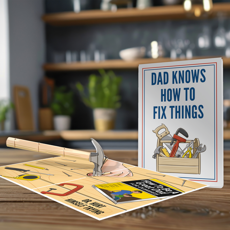 A 3D pop-up card depicting a hand holding a hammer with scattered tools and a humorous book, next to a matching card that reads DAD KNOWS HOW TO FIX THINGS, displayed on a kitchen counter.